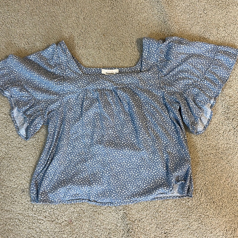 blue top with white polka dots